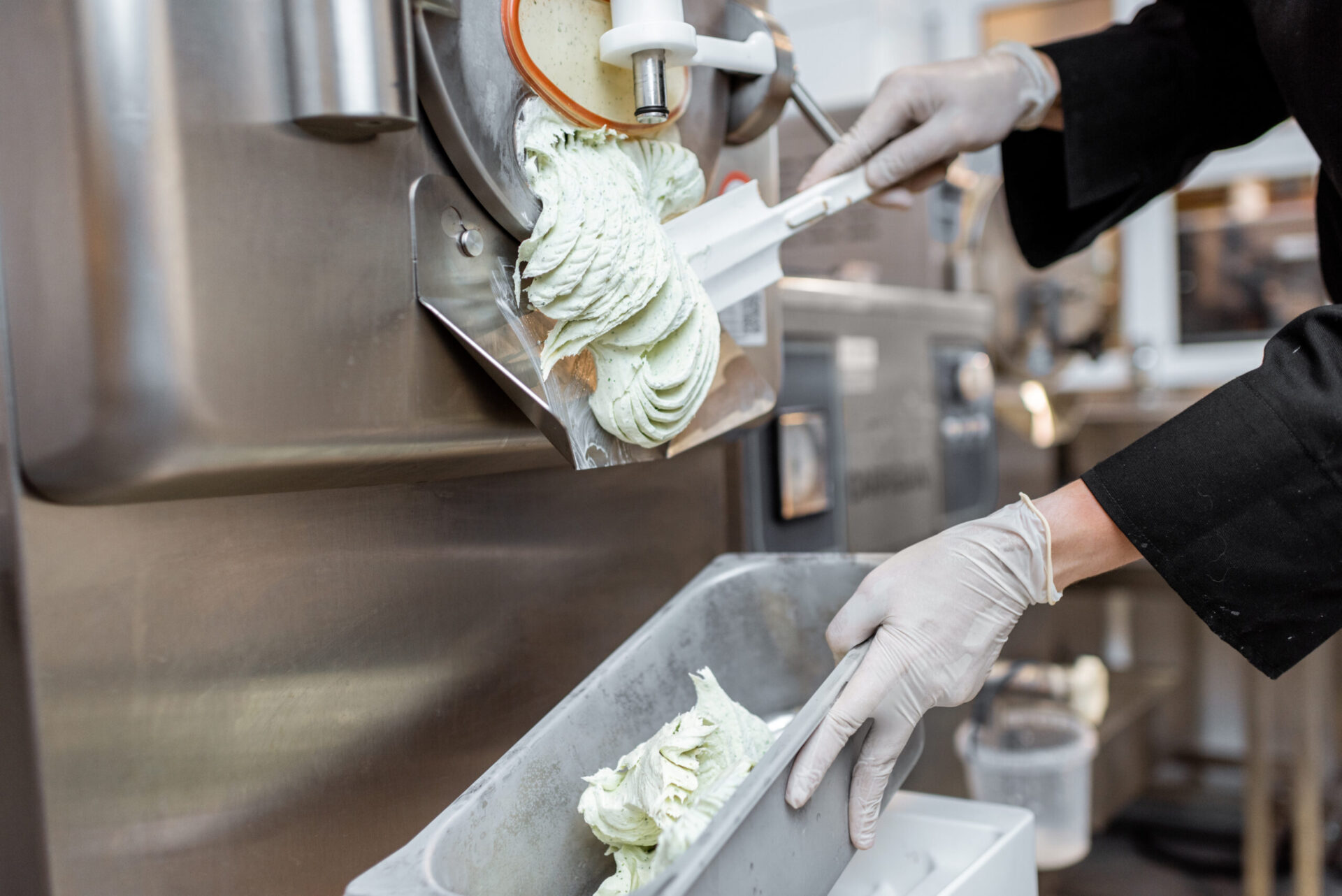 Pile of ready-made ice cream falling out of the freezer at the manufacturing, close-up